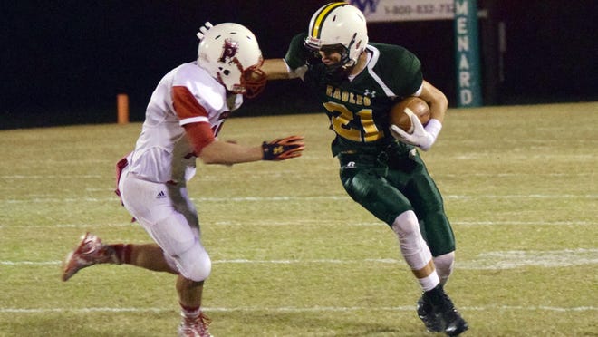 Menard's Adam Brown (21, right) delivers a stiff-arm to Pickering's Jordan Dowden (12, left) on Friday.