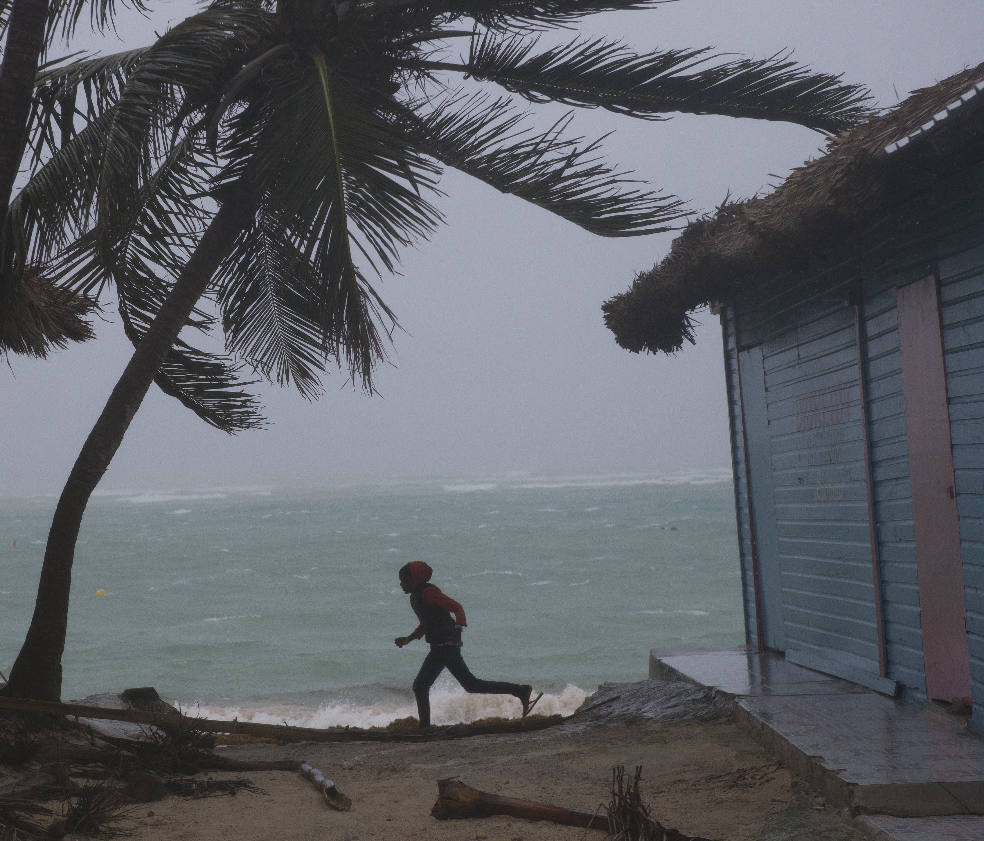 A child plays at El Cortecito beach hours before the arrival of hurricane Maria in Punta Cana, Dominican Republic, Sept. 20, 2017. The speed of Maria's winds reduced after landing in south east Puerto Rico but the danger remains according to the US N