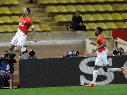 Monaco's Radamel Falcao celebrates scoring the opening goal while his teammate Thomas Lemar looks on during the Champions League Group G first leg soccer match between Monaco and Besiktas at Louis II stadium in Monaco, Tuesday, Oct. 17, 2017. (AP Photo/Claude Paris)