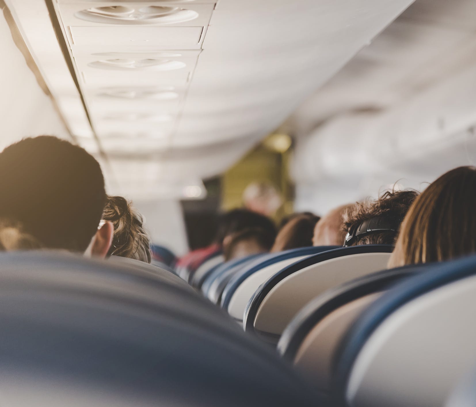 Whether you're within two seats of a sick person could determine whether you get infected, too.