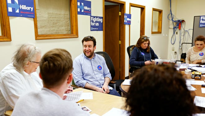 Dan Bram, a lead organizer with the Hillary Clinton presidential campaign, talks with volunteers before they all start making phone calls encouraging people to support Clinton in the upcoming Missouri Demoratic primary election.