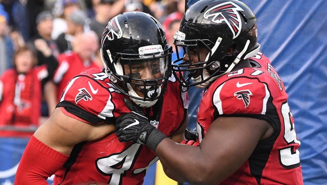 Atlanta Falcons defensive tackle Grady Jarrett (97) celebrates with outside linebacker Vic Beasley (44) after Beasley scored on a 21-yard touchdown on a fumble recovery in a game against the Los Angeles Rams on Dec. 11, 2016.