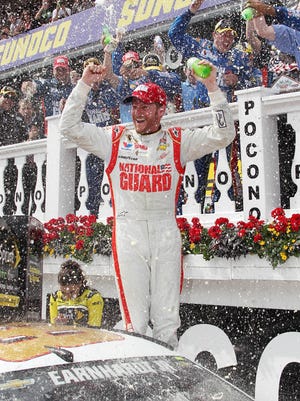 NASCAR Sprint Cup driver Dale Earnhardt Jr (88) celebrates in victory lane after winning the Pocono 400 at Pocono Raceway.