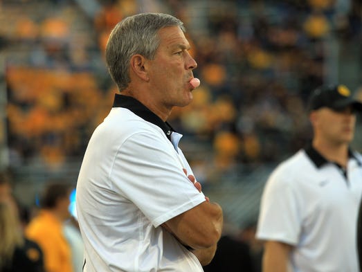 Iowa head coach Kirk Ferentz watches his team warm