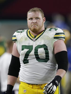 Green Bay Packers guard T.J. Lang (70) shows his disappointment after the Packers turned the ball over on downs late in the fourth quarter during their NFC divisional playoff game at University of Phoenix Stadium.