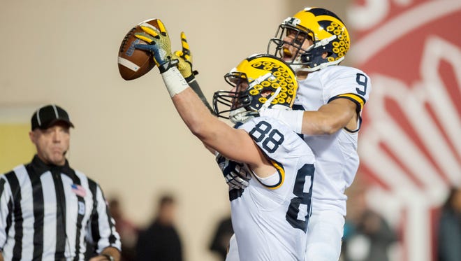 Jake Butt (88) and Grant Perry celebrate Butt's touchdown in the first overtime Saturday.