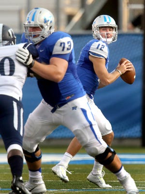 MTSU's quarteback Brent Stockstill (12) drops back to pass as Chandler Brewer keeps Jackson State away from Stockstill during the first half of an NCAA college football game against Jackson State, on Saturday, Sept. 5, 2014, in Murfreesboro, Tenn. (AP Photo/Daily News Journal, Helen Comer)