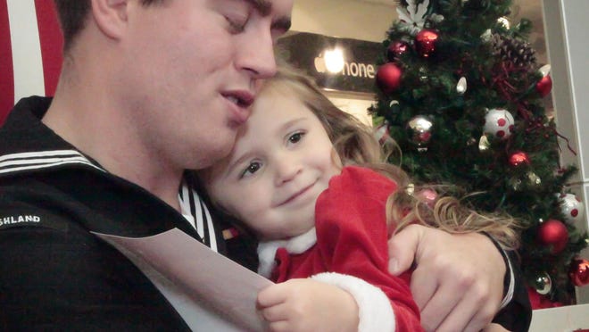 Happiness shows all around as Tyler Walters greet his daughter, 3-year-old Ava, during her visit with Santa at Stones River Mall.