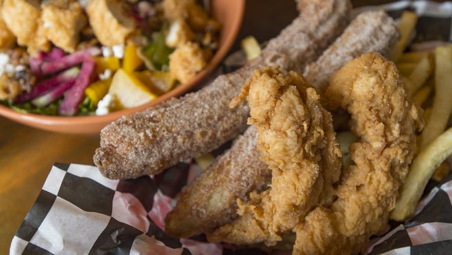 A basket of chicken and churros is served at Comet Chicken on Wednesday, November 1, 2017. The fried chicken joint, located on Mountain Avenue in Old Town is the latest creation from Hot Corner Concepts.