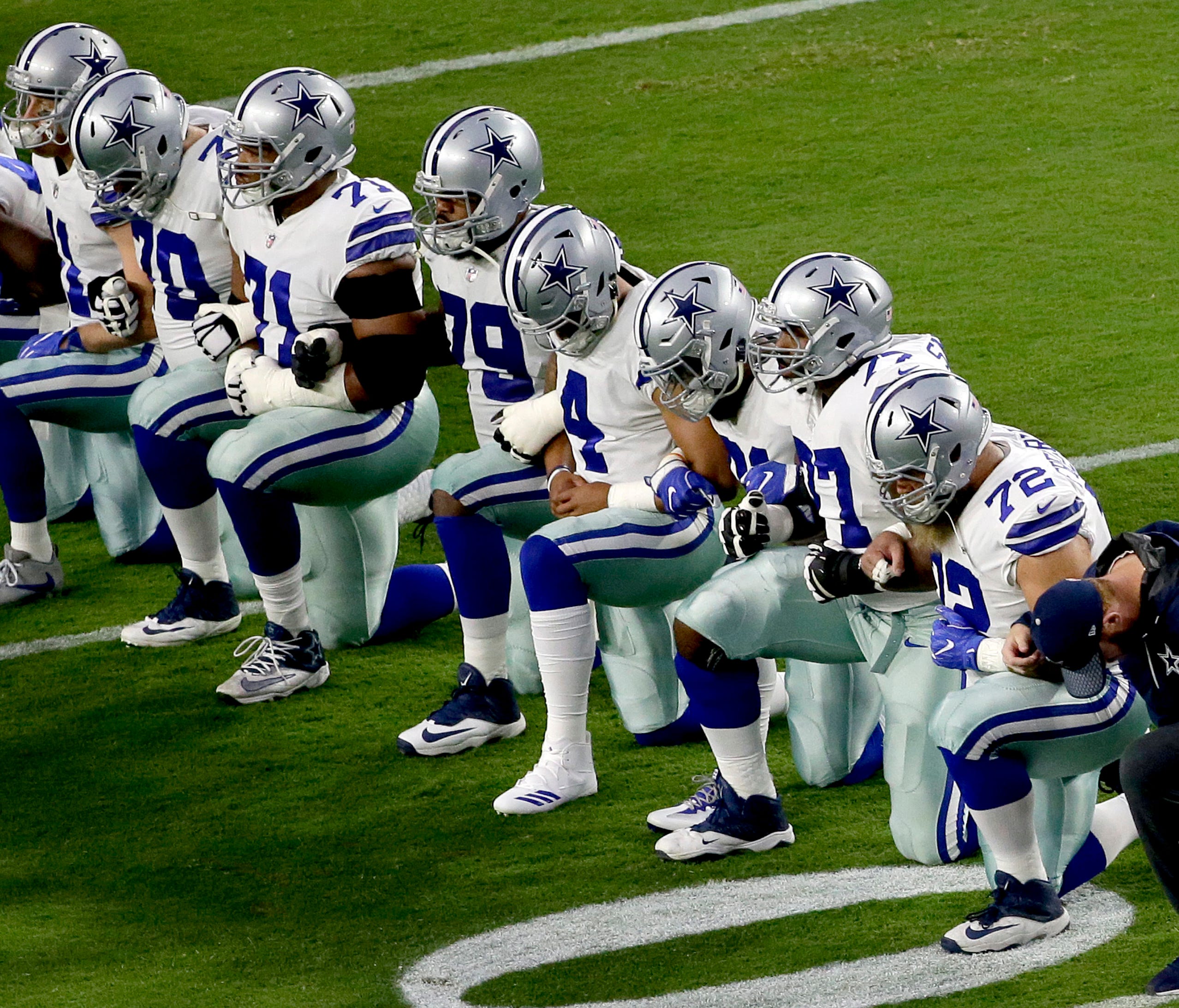 The Dallas Cowboys take a knee prior to the national anthem prior to an NFL football game against the Arizona Cardinals, Monday, Sept. 25, 2017, in Glendale, Ariz. (AP Photo/Matt York) ORG XMIT: AZMY