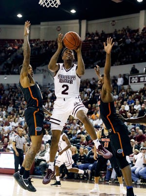 Mississippi State guard Eli Wright (2) splits two Florida defenders as he shoots in the second half of an NCAA college basketball game in Starkville.