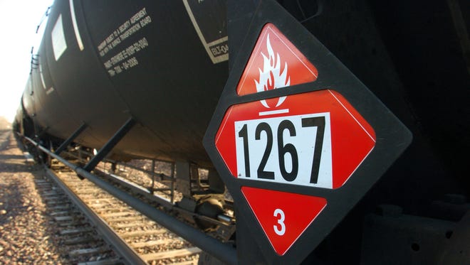 A warning placard on a tank car carrying crude oil is seen on a train idled on the tracks near a crude loading terminal in Trenton, N.D. on Nov. 6, 2013.