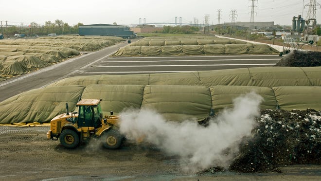 
A bulldozer moves compost at Peninsula Compost’s Wilmington Organics Recycling Center, near the Port of Wilmington, in 2010.
