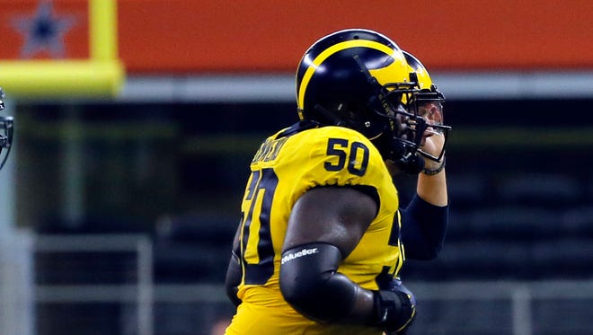 Michigan offensive lineman Michael Onwenu is taking on a bigger role in the Wolverines' power rushing game.
