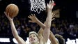 Michigan forward Moritz Wagner, left, drives to the
