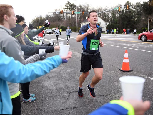 Ben Mills runs past the water station on Kingston Pike
