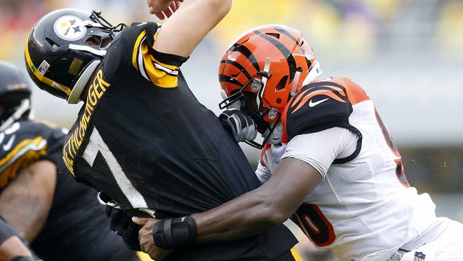 Pittsburgh Steelers quarterback Ben Roethlisberger (7) is brought down by Cincinnati Bengals defensive end Carlos Dunlap (96) after throwing a pass in the second quarter of the NFL Week 2 game between the Pittsburgh Steelers and the Cincinnati Bengals at Heinz Field in Pittsburgh on Sunday, Sept. 18, 2016. At the half, the Bengals trailed 10-6.