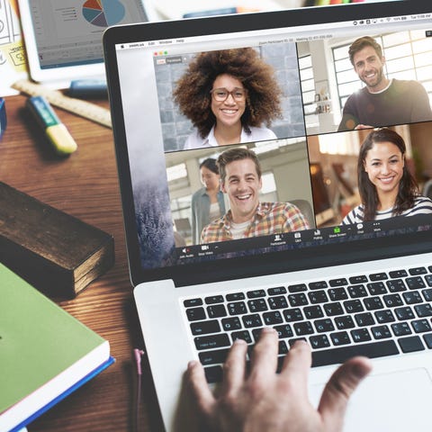 A person on a laptop videoconferencing with four o