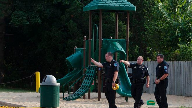 
Kentwood police investigate a stabbing that occurred in a playground in Pinebrook Village, in Kentwood, Mich., on Aug. 4, 2014. Police say a 12-year-old boy has stabbed a 9-year-old boy at the playground in western Michigan, sending the child to a hospital. Police also didn't immediately release detail on the condition of the wounded child. The older boy was taken into custody for questioning by police. (AP Photo/The Grand Rapids Press, Joel Bissell) 
