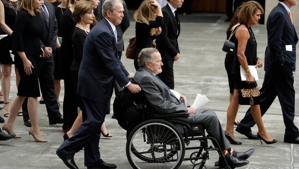 Former president George W. Bush pushes his...