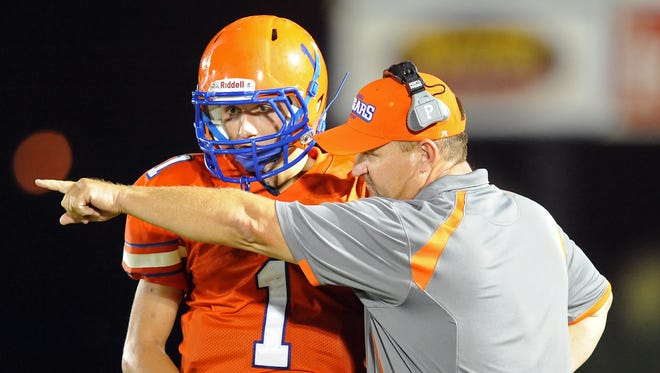 Columbia Academy coach Larry Dolan talks with player Wiley Cleland (1) during a game last season in Columbia.