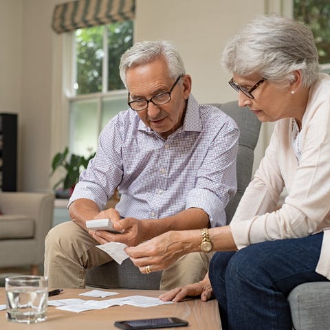 Two seniors reviewing financial paperwork.