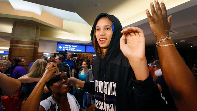 Phoenix Mercury center Brittney Griner is swarmed by fans as she arrives at Phoenix Sky Harbor International Airport   in September.