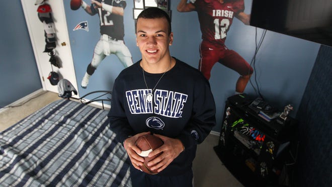Aquinas junior quarterback Jake Zembiec, shown in the bedroom of his Gates home.