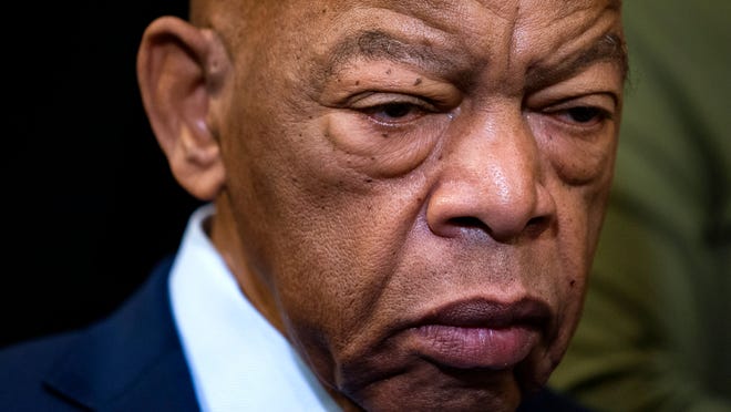 In this Friday, Dec. 6, 2019, file photo, civil rights leader U.S. Rep. John Lewis, D-Ga., is extolled at an event with fellow Democrats before passing the Voting Rights Advancement Act to eliminate potential state and local voter suppression laws, at the Capitol in Washington. Lewis, who carried the struggle against racial discrimination from Southern battlegrounds of the 1960s to the halls of Congress, died Friday, July 17, 2020.