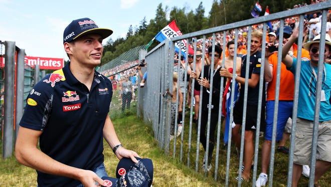 Max Verstappen throws caps to the fans before the Belgian Grand Prix Sunday.
