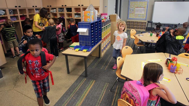 Kindergartners grab their backpacks as class ends at Alexander Elementary on Monday, Aug. 24, 2015.