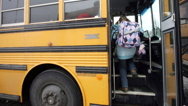Student boards the school bus.