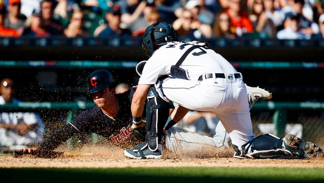 Indians centerfielder Tyler Naquin (30) is tagged out at home by Tigers catcher James McCann (34) in the seventh inning of the Tigers' 6-0 loss Saturday at Comerica Park.