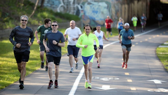 Downtown Runners and Walkers Detroit group members run through the Dequindre Cut on Wednesday, May 3, 2016, in Detroit.