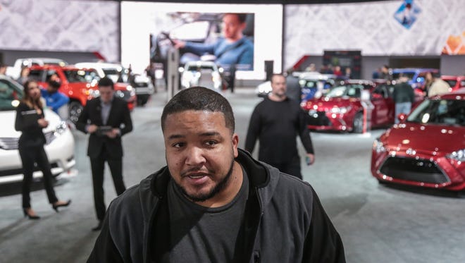 Steven Sellers, 38, of Garden City talks about the cost of owning a new car on Tuesday January 17, 2017 at the Toyota exhibit during the 2017 North American International Auto Show at Cobo Center in Detroit.