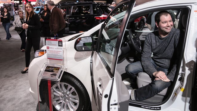 Ryan Fortenbacher, 35, of Columbus, Ohio talks about the cost of owning a new car on Tuesday January 17, 2017 while sitting in a 2017 Toyota Sienna at the Toyota exhibit during the 2017 North American International Auto Show at Cobo Center in Detroit.