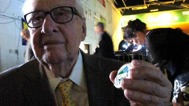 
Businessman and philanthropist Tony Pomerleau, 97, shows a medal of appreciation given to him Saturday by Vermont National Guard Adjutant Gen. Steven Cray at the University of Vermont.


