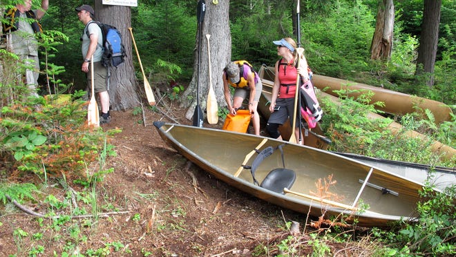 
In this photo taken on July 8, paddlers prepare to launch their canoes at a rugged launch site on Deer Pond in the Essex Chain Lakes tract near Newcomb. The tract, which includes more than a dozen small lakes, was purchased by the state in 2012 and opened for canoe camping this summer.
