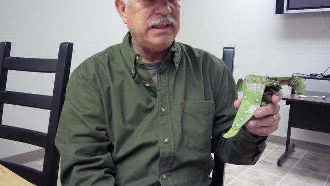 Bill Murphy, a local aviation enthusiast, shows off a piece of metal that he recovered from the Dec. 1, 1974, plane crash site in Harriman State Park.