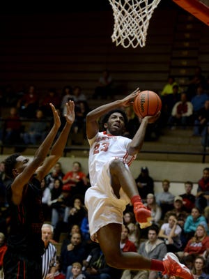 Richmond's Adrion Gibson goes to the basket against Arsenal Tech's Ernest Myles during a boys basketball game Friday, Dec. 18, 2015, in the Tiernan Center.