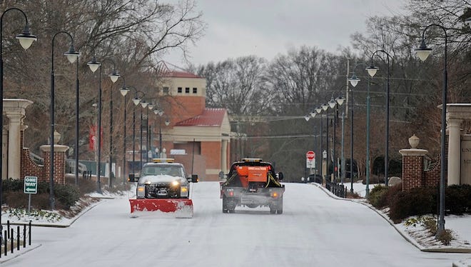 University of Mississippi physical plant workers clear a roadway on the campus in Oxford, Miss., Thursday, March 5, 2015. Sleet and snow continued Thursday morning across a wide belt of Mississippi, even as precipitation ended in the northwest part of the state.