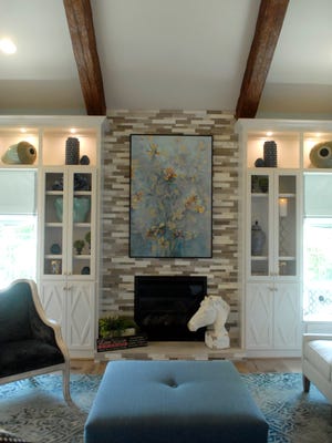 A stone fireplace in the great room at this Homearama River Crest home called "The Himmel," built by Richard Miles with design by Lisa Lynn Knight of Lisa Lynn Designs. July 11, 2016