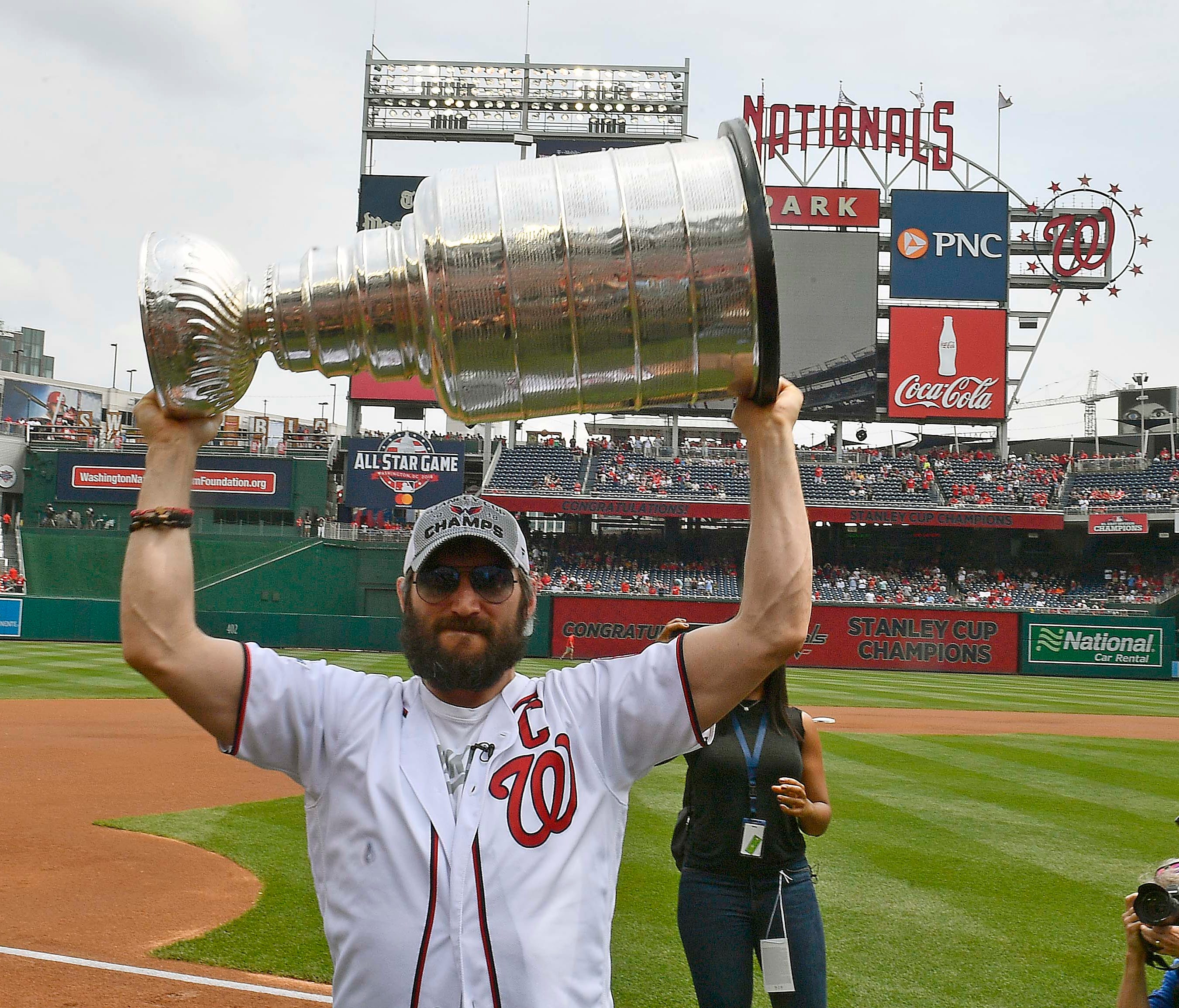 Alex Ovechkin hoists the Stanley Cup at the Washington Nationals game on Saturday.
