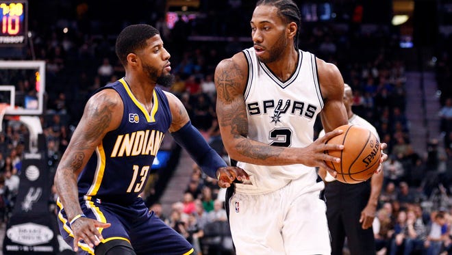 San Antonio Spurs small forward Kawhi Leonard (2) is defended by Indiana Pacers small forward Paul George (13) during the first half at AT&T Center.