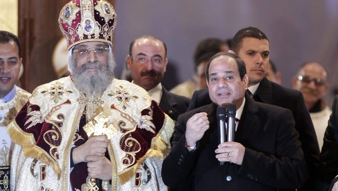 Egyptian President Abdel Fattah al-Sisi (R), speaks at the Coptic Cathedral of Saint Marcos in Cairo, Egypt, Jan. 6 2015