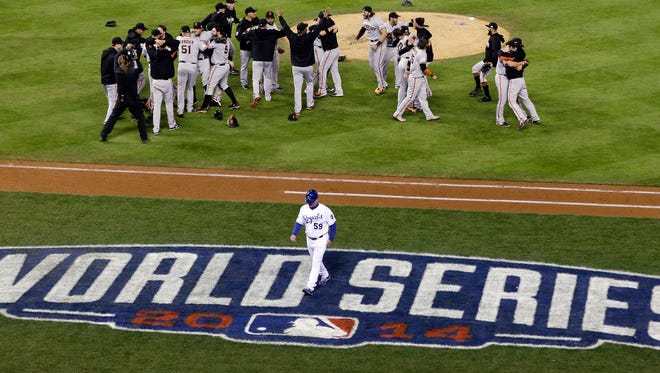 The San Francisco Giants celebrate after Game 7 of baseball's World Series against the Kansas City Royals.