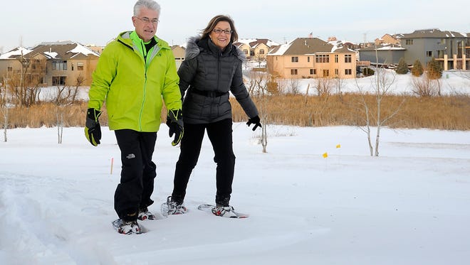 John Porter and his wife, Penny, snowshoe in their backyard in Sioux Falls in 2014.