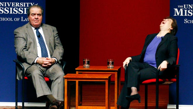 In a Monday, Dec. 15, 2014 file photo, U.S. Supreme Court Justice Antonin Scalia, left, relates a story about his years as a law student while fellow Justice Elena Kagan laughs, at the University of Mississippi in Oxford, Miss. Mississippi Republicans are fondly remembering U.S. Supreme Court Justice Antonin Scalia, who frequently hunted in Mississippi along his friend, retired 5th Circuit U.S. Court of Appeals Judge Charles Pickering. Scalia was found dead at a Texas ranch Saturday, Feb. 13, 2016,  where he had gone to hunt quail. (AP Photo/Rogelio V. Solis, File)