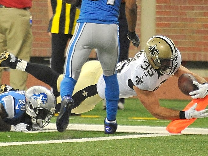 Saints' Austin Johnson dives for the pylon and scores