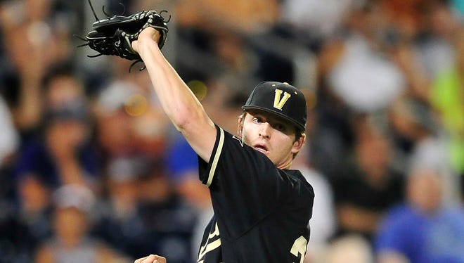 Vanderbilt pitcher Hayden Stone catches an infield fly ball during the eighth inning against Texas at the College World Series at TD Ameritrade Park in Omaha, Neb., Saturday, June 21, 2014.